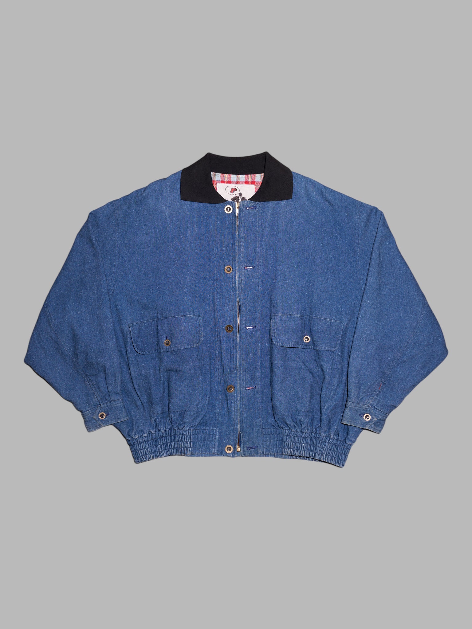 Person's 1980s indigo denim flannel lined bomber jacket