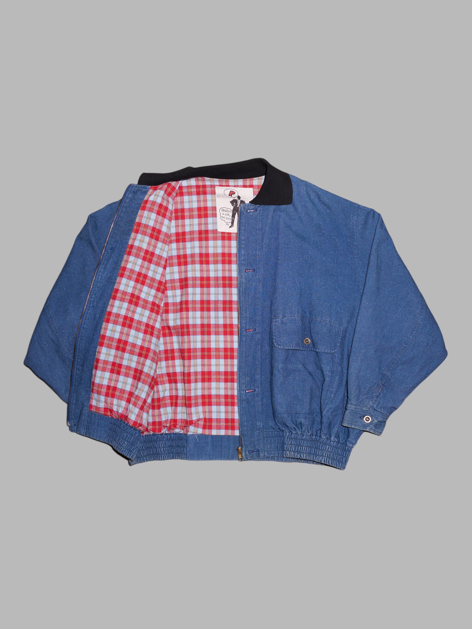 Person's 1980s indigo denim flannel lined bomber jacket