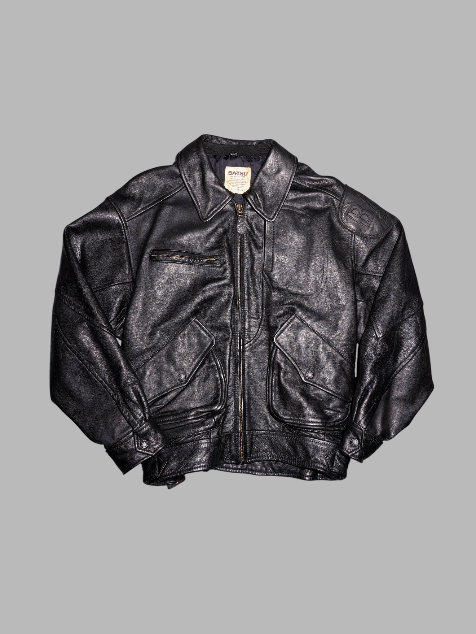 Ba-tsu 1980s thick black leather bomber jacket with shoulder patch