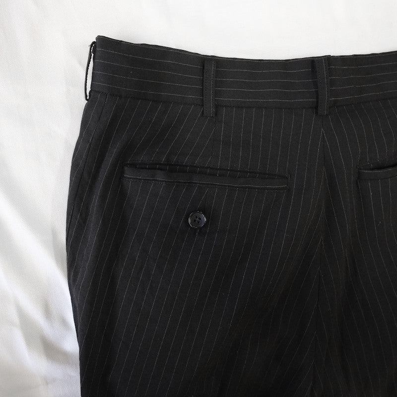 curved pinstripe trousers